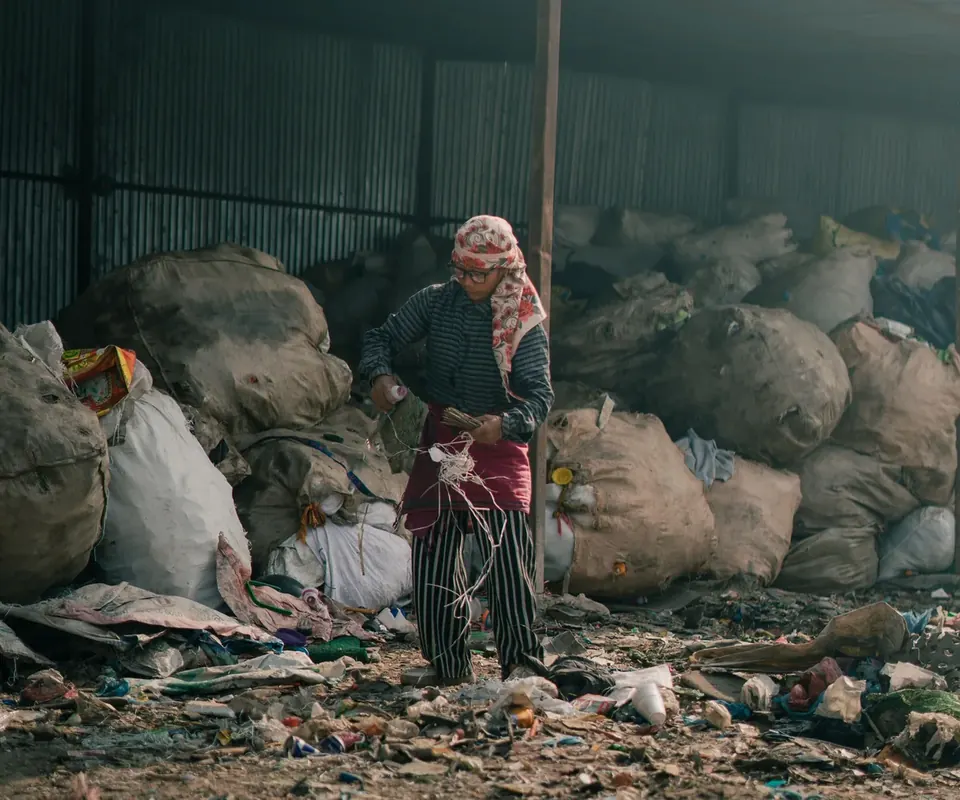 Worker sorting materials at a recovery facility